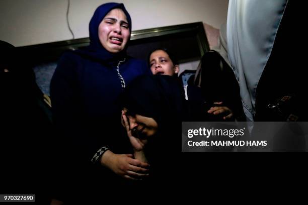 Palestinian relatives mourn over the death of 29-year-old Yussef al-Fassih during his funeral after he was shot dead by Israeli soldiers the day...