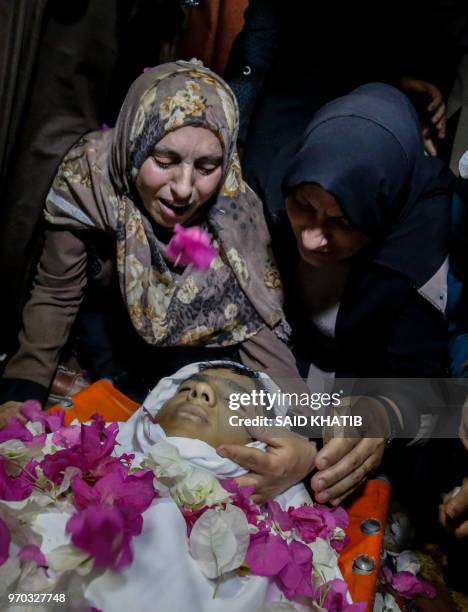 Graphic content / The mother of Haitham al-Jamal mourns over the body of the 15-year-old Palestinian who was fatally shot by Israeli troops the day...