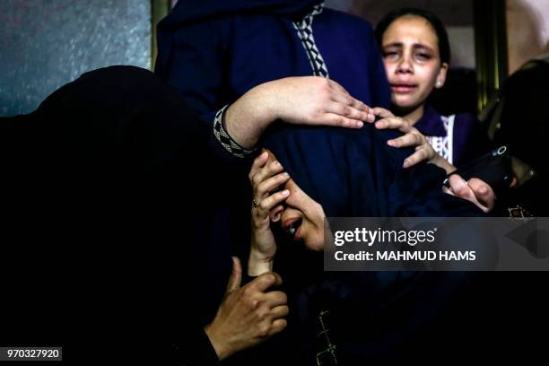 Palestinian relatives mourn over the death of 29-year-old Yussef al-Fassih during his funeral after he was shot dead by Israeli soldiers the day...