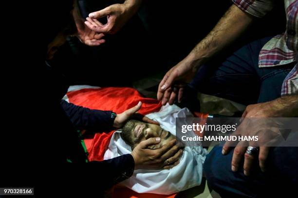Palestinian relatives mourn over the death of 29-year-old Yussef al-Fassih during his funeral after he was shot dead by Israeli soldiers the day...