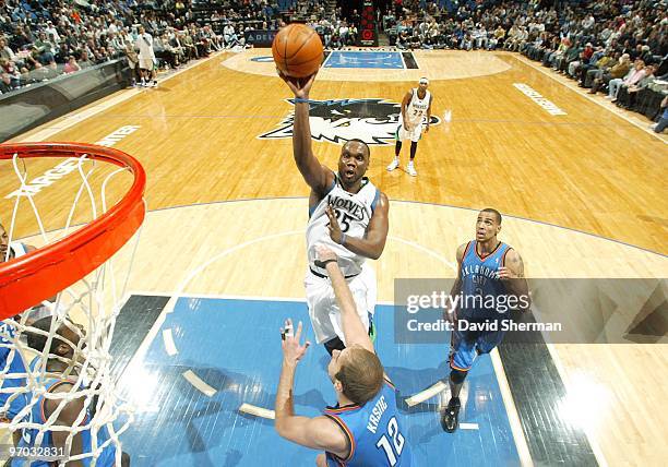 Al Jefferson of the Minnesota Timberwolves shoots over Nenad Krstic of the Oklahoma City Thunder during the game at Target Center on February 21,...