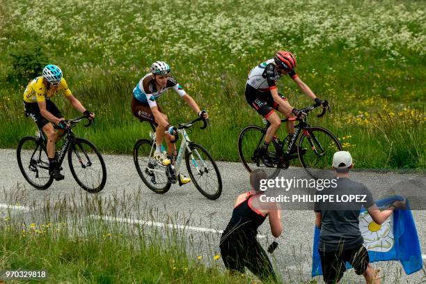 Britain's Geraint Thomas, wearing the overall leader's yellow jersey, France's Romain Bardet and Ireland's Daniel Martin ride in the last kilometers...
