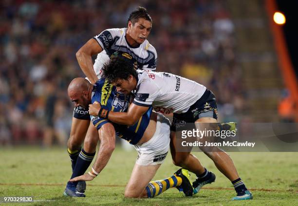 Tim Mannah of the Eels is tackled during the round 14 NRL match between the Parramatta Eels and the North Queensland Cowboys at TIO Stadium on June...