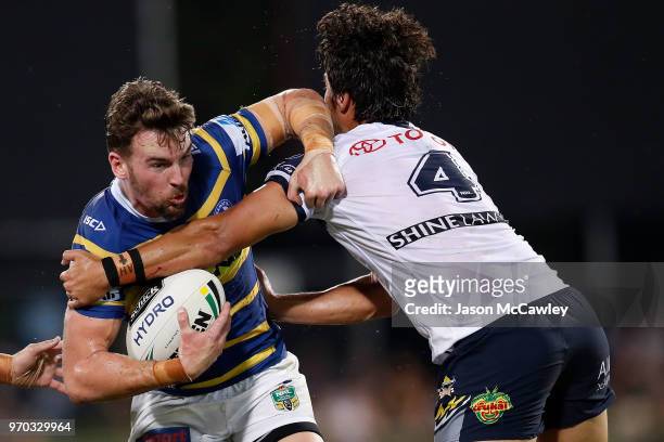 Clint Gutherson of the Eels is tackled by Enari Tuala of the Cowboys during the round 14 NRL match between the Parramatta Eels and the North...