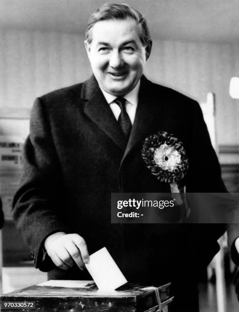 British Chancellor of the Exchequer James Callaghan, wearing a cockade, votes in March 1966, in Cardiff.