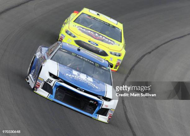 Alex Bowman, driver of the Nationwide Chevrolet, leads Paul Menard, driver of the Menards/Jack Liks Ford, during practice for the Monster Energy...