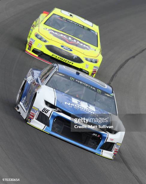 Alex Bowman, driver of the Nationwide Chevrolet, leads Paul Menard, driver of the Menards/Jack Liks Ford, during practice for the Monster Energy...