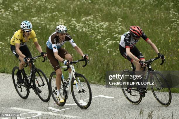 Britain's Geraint Thomas, wearing the overall leader's yellow jersey, France's Romain Bardet and Ireland's Daniel Martin ride in the last kilometers...