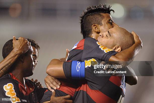 Player Leo Moura of Flamengo celebrates his scored goal with his teammate Adriano during their soccer match against Universidad Catolica as part of...