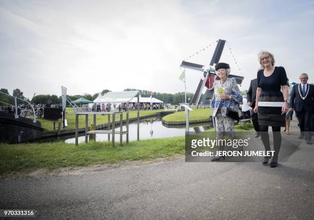 Dutch Princess Beatrix walks as she attends the opening of the Mill of Polder Buitenweg in Oud-Zuilen, on June 9, 2018. - The smallest mill in the...