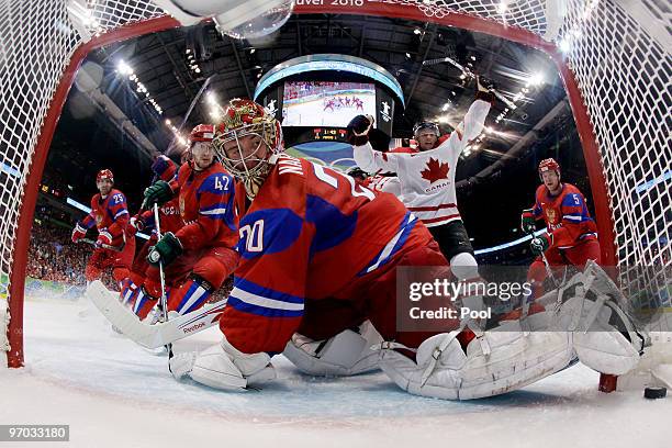 Evgeny Nabokov of Russia gives up a goal against Brenden Morrow of Canada in the first period during the ice hockey men's quarter final game between...