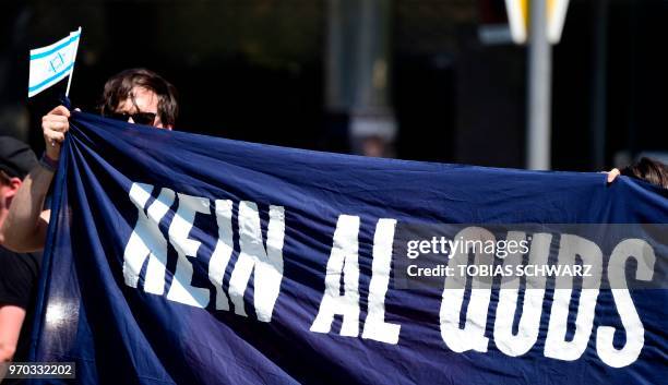 Protester holds a banner reading "No Al Quds" during an anti-Quds-day Demonstration on the occasion of the so-called "Al-Quds day" in Berlin, on June...