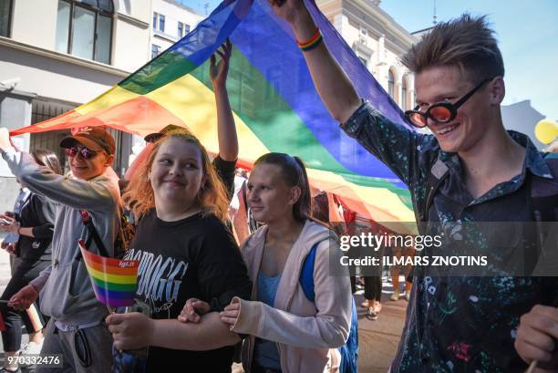 Protesters take part in the Baltic gay pride parade in Riga, on June 9, 2018. - LGBT groups from Estonia, Latvia and Lithuania gather for the Baltic...