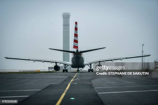 An air plane is pictured on the runway on June 8, 2018 at Roissy Charles de Gaulle airport, north of Paris.