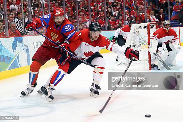 Brent Seabrook of Canada fights for the puck against Alexey Morozov of Russia during the ice hockey men's quarter final game between Russia and...