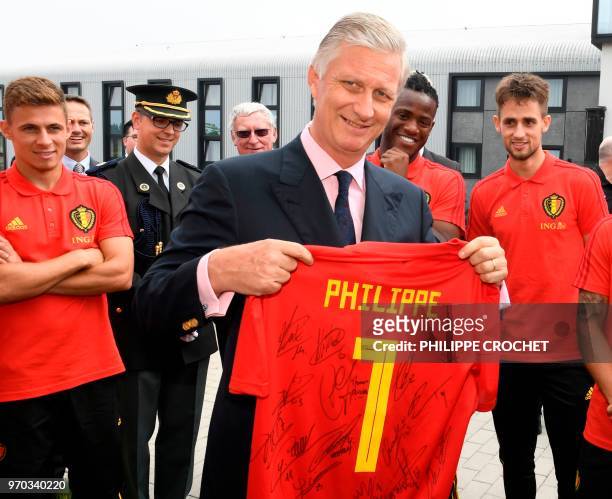 King Philippe of Belgium poses with a Red Devils shirt during a visit to the a training session of the Belgian national football team Red Devils, on...