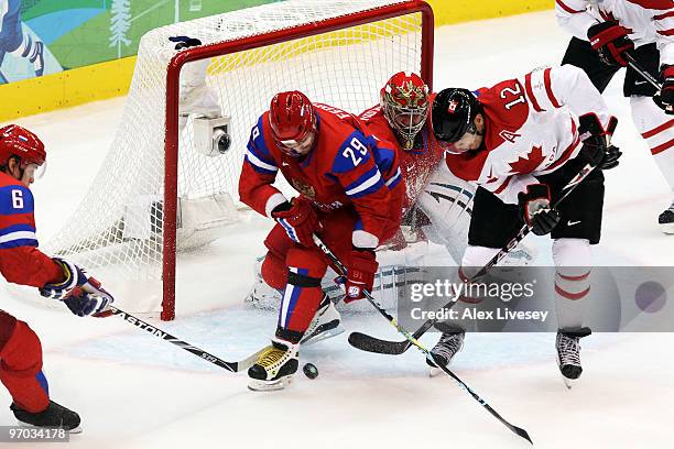 Sergey Fedorov of Russia battles for the puck with Jarome Iginla of Canada during the ice hockey men's quarter final game between Russia and Canada...