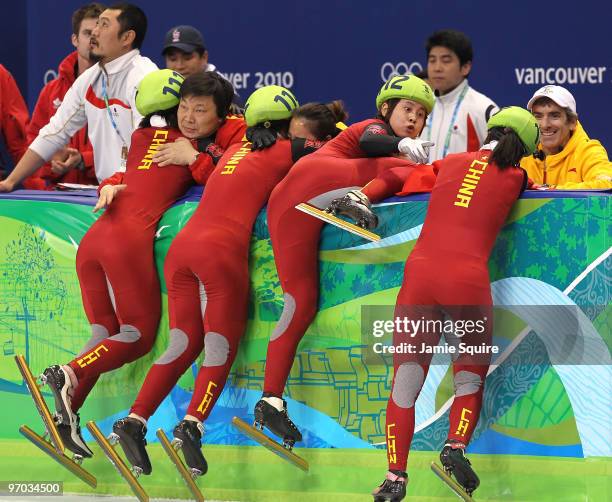 Wang Meng of China reacts after cutting the face of teammate Zhang Hui after Team China won the gold medal in the Short Track Speed Skating Ladies'...