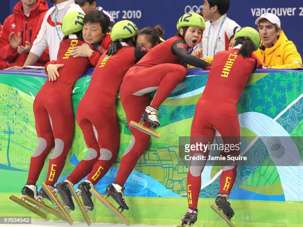 Wang Meng of China reacts after cutting the face of teammate Zhang Hui after Team China won the gold medal in the Short Track Speed Skating Ladies'...