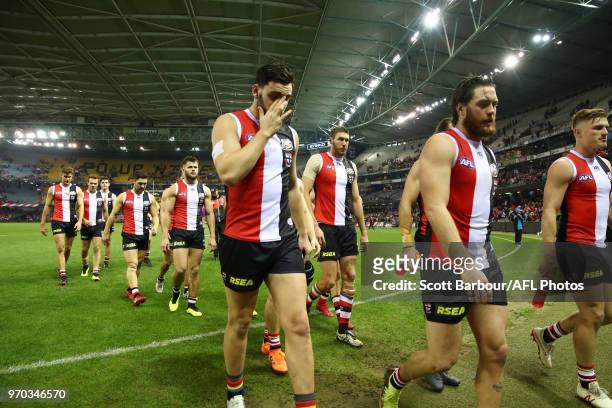 Paddy McCartin of the Saints, Jack Steven of the Saints and their teammates leave the field after losing the round 12 AFL match between the St Kilda...