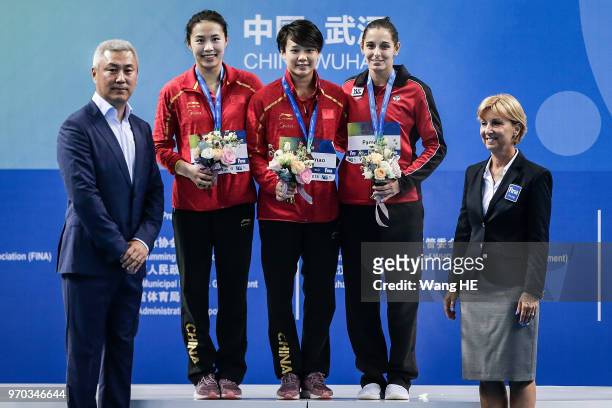 Silver medalist Han Wang of China, gold medalist Tingmao Shi of China and bronze medalist Pamela Ware of Canada pose on the podium at the medal...