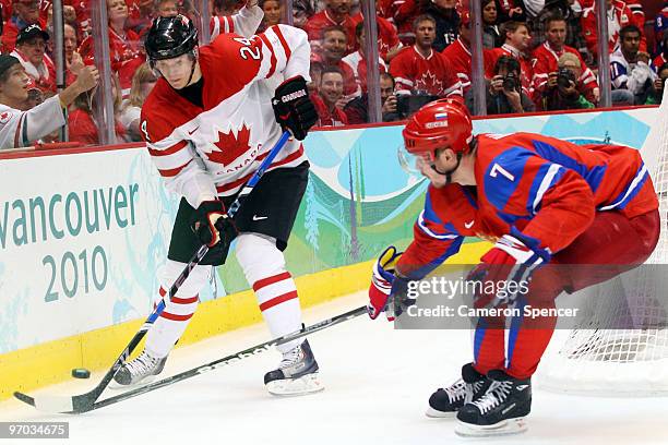 Corey Perry of Canada battles for the puck with Dmitri Kalinin of Russia during the ice hockey men's quarter final game between Russia and Canada on...