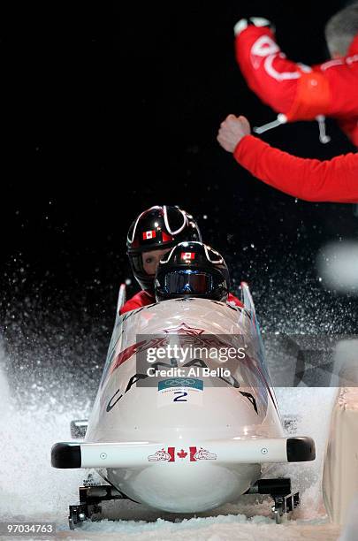 Kaillie Humphries and Heather Moyse of Canada in Canada 1 complete their fourth run to finish in first place and win the gold during the womens...