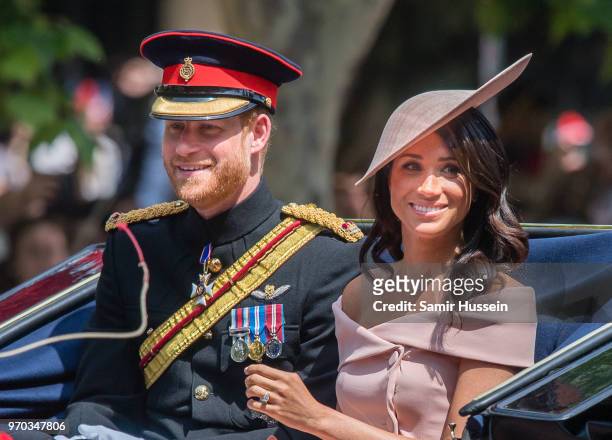 Prince Harry, Duke of Sussex and Meghan, Duchess of Sussex ride by carriage during Trooping The Colour 2018 on the Mall on June 9, 2018 in London,...