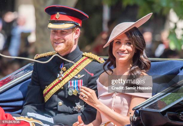 Prince Harry, Duke of Sussex and Meghan, Duchess of Sussex ride by carriage during Trooping The Colour 2018 on the Mall on June 9, 2018 in London,...