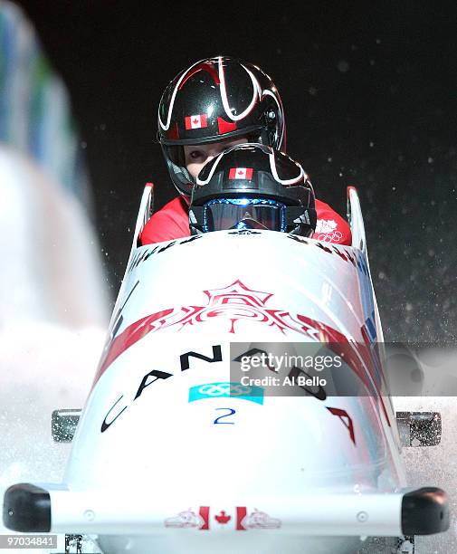 Kaillie Humphries and Heather Moyse of Canada in Canada 1 complete their fourth run to finish in first place and win the gold during the womens...