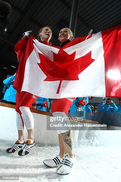 Heather Moyse and Kaillie Humphries of Canada celebrate winning gold during the women's bobsleigh on day 13 of the 2010 Vancouver Winter Olympics at...