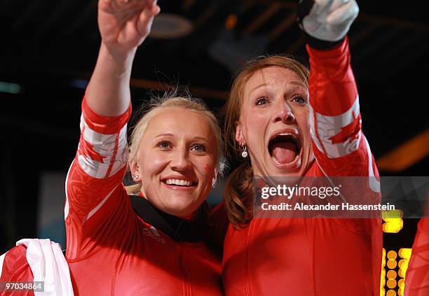 Heather Moyse and Kaillie Humphries of Canada celebrate winning gold during the women's bobsleigh on day 13 of the 2010 Vancouver Winter Olympics at...