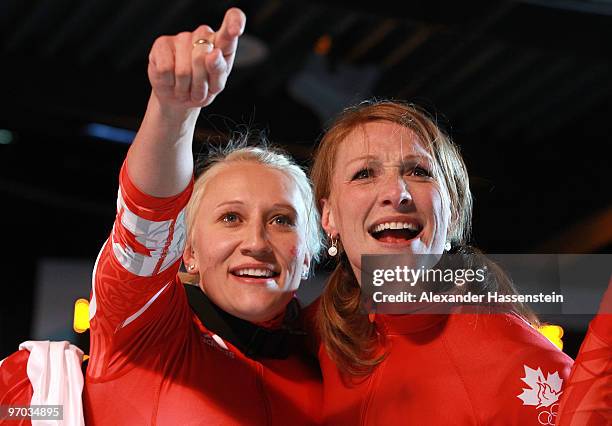 Heather Moyse and Kaillie Humphries of Canada celebrate winning gold during the women's bobsleigh on day 13 of the 2010 Vancouver Winter Olympics at...