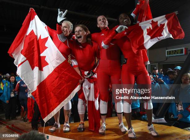 Heather Moyse and Kaillie Humphries of Canada 1 celebrate gold and Helen Upperton and Shelly-Ann Brown of Canada 2 celebrate silver after the women's...