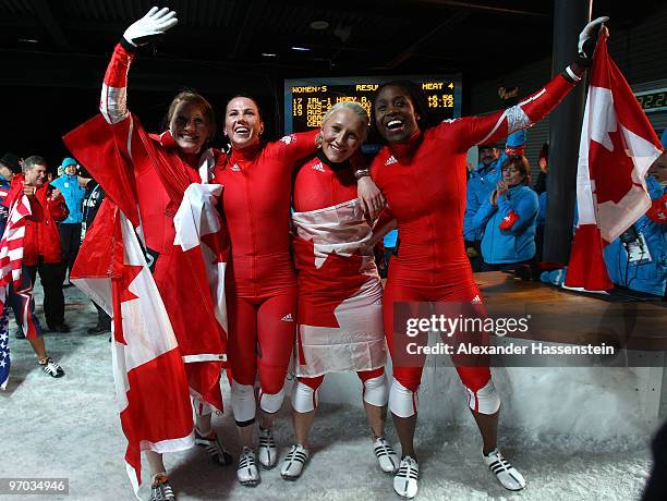 Heather Moyse and Kaillie Humphries of Canada 1 celebrate gold and Helen Upperton and Shelly-Ann Brown of Canada 2 celebrate silver after the women's...