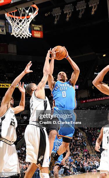 Russell Westbrook of the Oklahoma City Thunder shoots against George Hill of the San Antonio Spurs on February 24, 2010 at the AT&T Center in San...