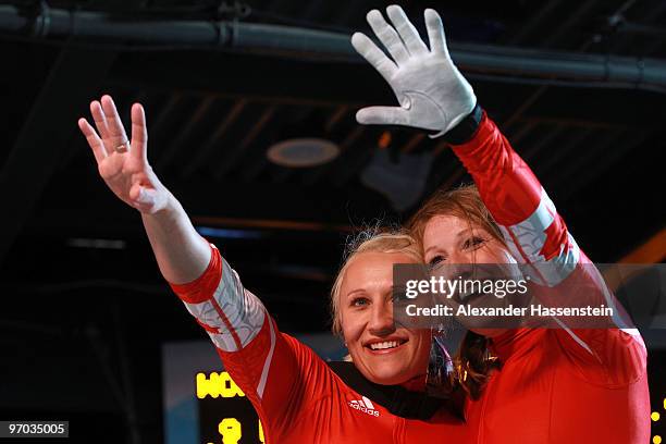 Heather Moyse and Kaillie Humphries of Canada celebrate winning gold during the women's bobsleigh on day 13 of the 2010 Vancouver Winter Olympics at...