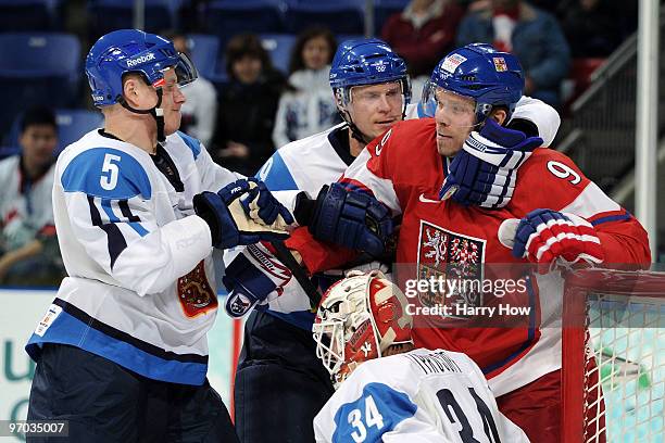 Milan Michalek of Czech Republic draws contact against Lasse Kukkonen and Niko Kapanen of Finland during the ice hockey men's quarter final game...