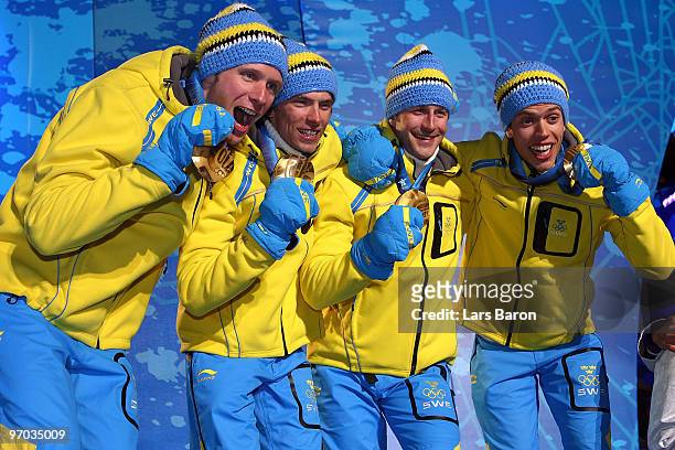 Sweden celebrate winning the gold medal for the cross country skiing men's 4 x 10 km relayduring the medal ceremony on day 13 of the Vancouver 2010...