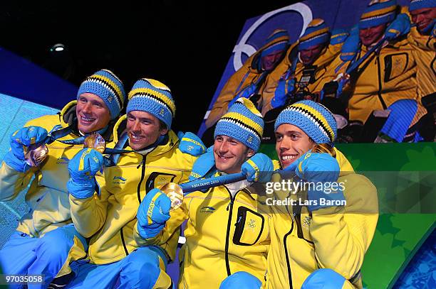 Sweden celebrate winning the gold medal for the cross country skiing men's 4 x 10 km relay during the medal ceremony on day 13 of the Vancouver 2010...