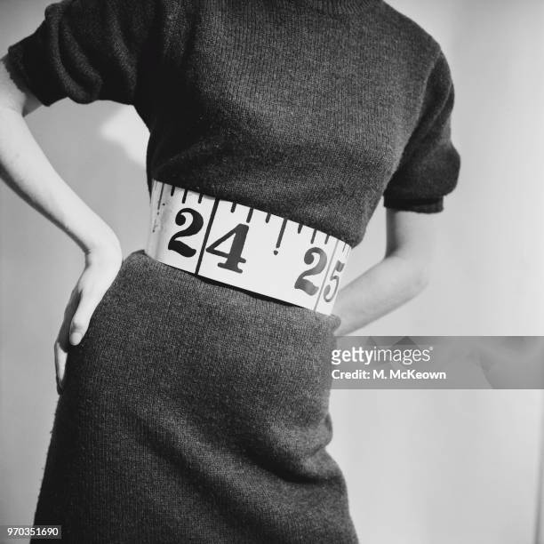 Fashion model wearing short sleeves wool dress with tape measure belt, UK, 23rd January 1967.