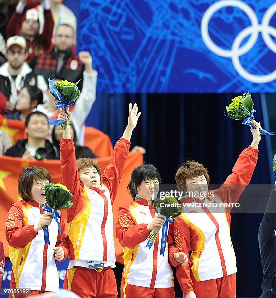 China's gold medalists Linlin Sun, Meng Wang, Hui Zhang and Yang Zhou celebrate in the flower ceremony of the Women's Short Track Speedskating 3000m...