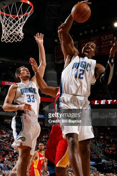 Dwight Howard of the Orlando Magic rebounds the ball against the Houston Rockets on February 24, 2010 at the Toyota Center in Houston, Texas. NOTE TO...