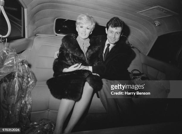 American singer and actor Eddie Fisher with his fiancee, American actress, singer and producer Connie Stevens, sitting in the back of a car after...