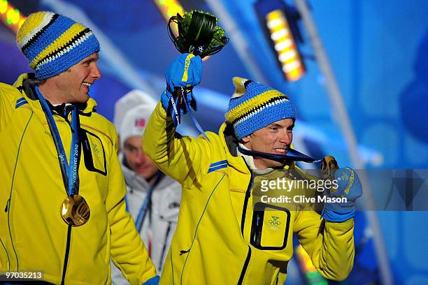 Daniel Richardsson and Johan Olsson of Sweden celebrate winning the gold medal for the cross country skiing men's 4 x 10 km relay during the medal...
