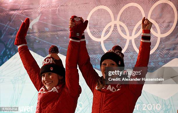 Heather Moyse and Kaillie Humphries of Canada 1 celebrate gold during the flower ceremony the women's bobsleigh on day 13 of the 2010 Vancouver...