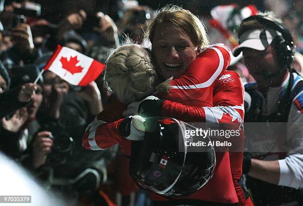 Heather Moyse and Kaillie Humphries of Canada celebrate winning gold during the women's bobsleigh on day 13 of the 2010 Vancouver Winter Olympics at...