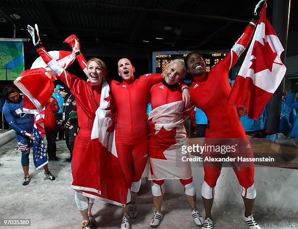 Heather Moyse and Kaillie Humphries of Canada 1 celebrate gold and Helen Upperton and Shelly-Ann Brown of Canada 2 celebrate silver after the women's...