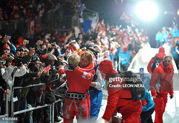 The Canada-1 women bobsleigh pilot Kaillie Humphries and brakeman Heather Moyse celebrate winning gold in the two-man bobsleigh event in the...