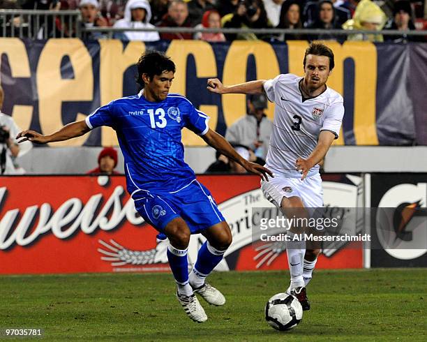 Midfielder Eddie Gaven of the U. S. Men's Soccer Team battles defender Deris Umanzor of El Salvador February 24, 2010 at Raymond James Stadium in...